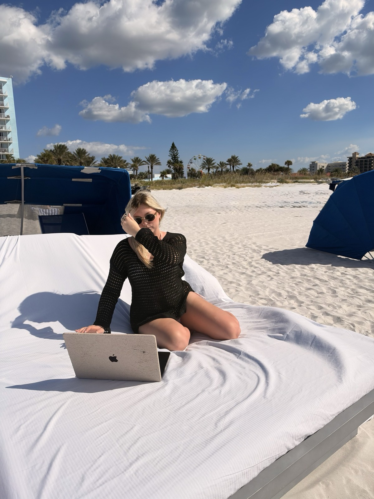 kaelee working on her laptop on a beach cabana