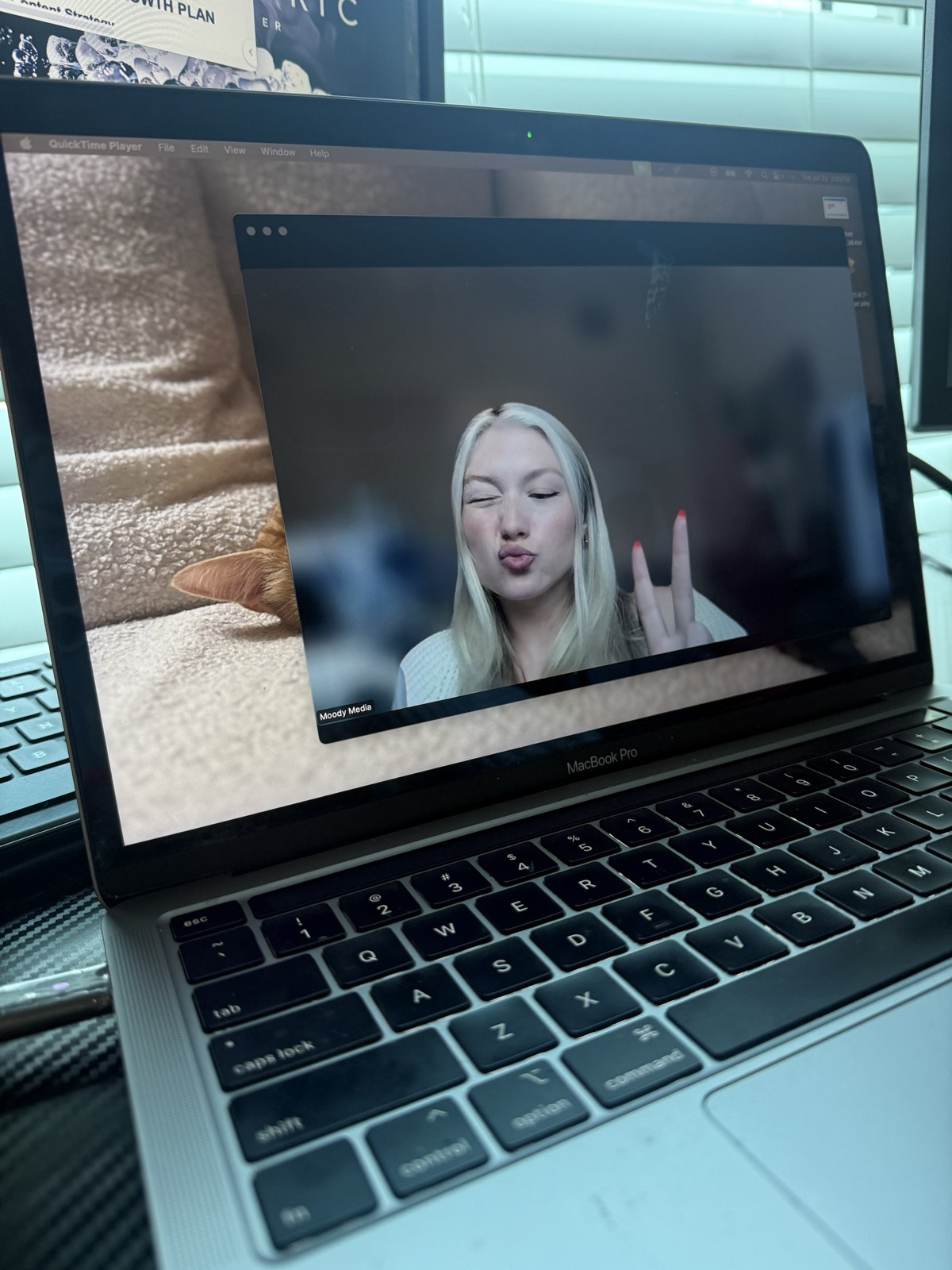 kaelee on a video call throwing a peace sign